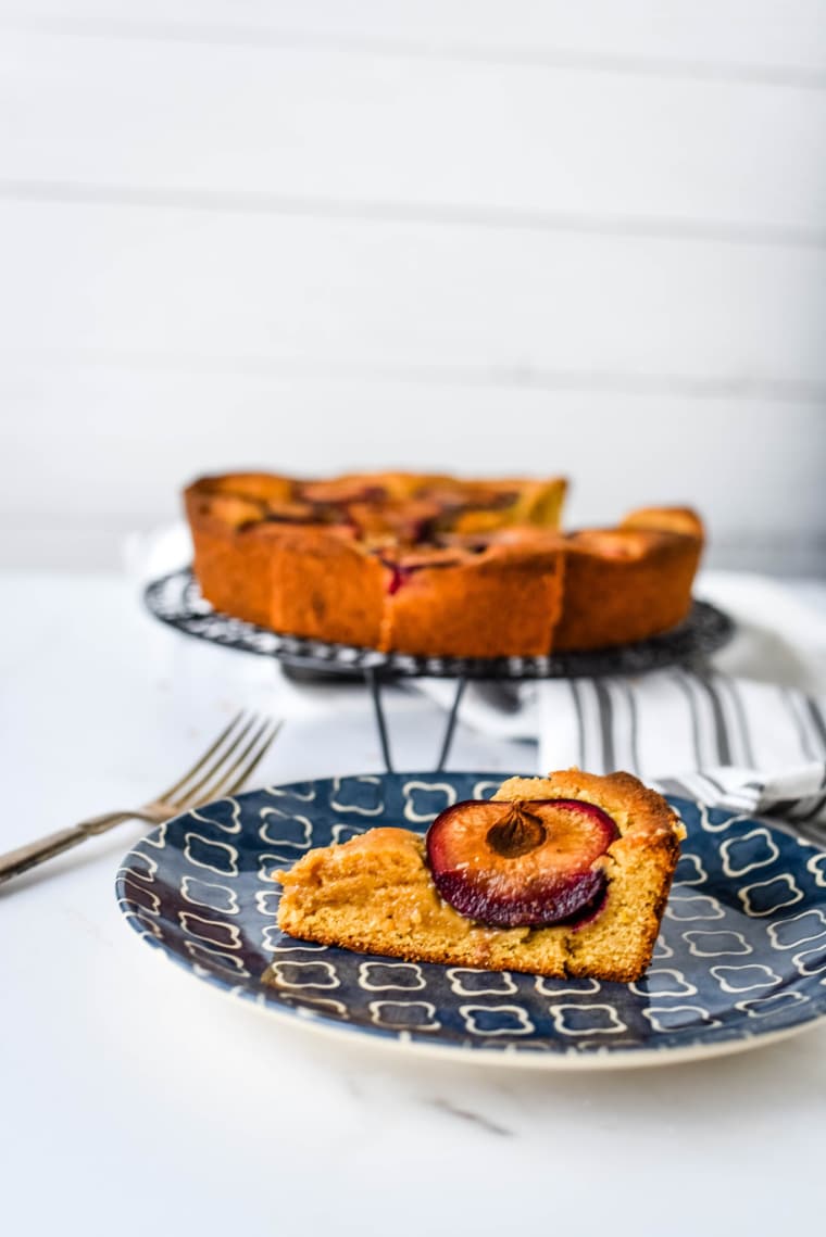 plum cake on blue plate with fork