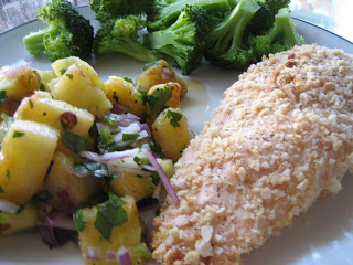 A plate of food with broccoli, chicken and pineapple salsa