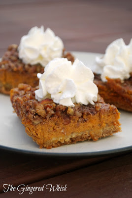 pumpkin bars with pecan topping and whipped cream