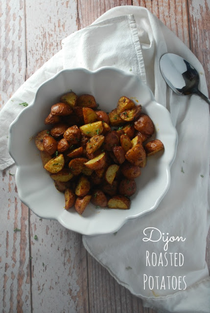 overhead view of white bowl filled with roasted potato bites