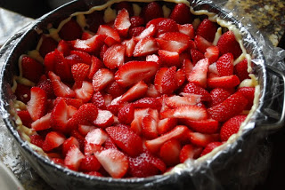 sliced strawberries placed in fraisier cake