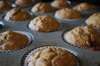 freshly baked banana date muffins in muffin tray