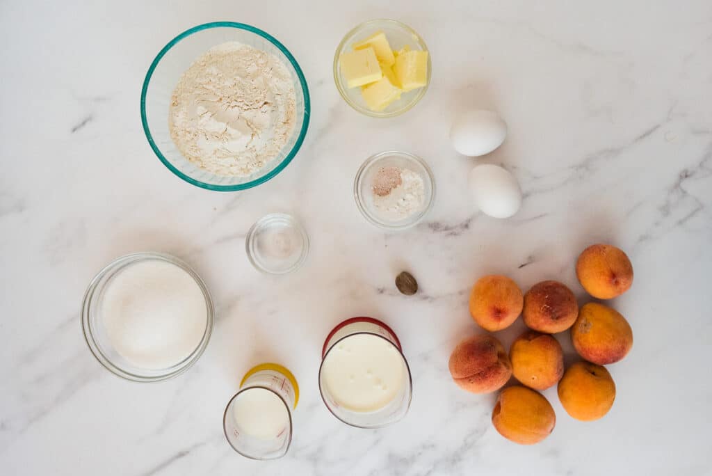 ingredients for peach kitchen in glass bowls on marble counter