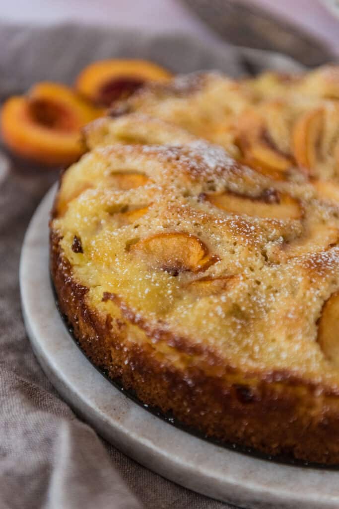 closeup view of German peach kuchen cake on serving platter