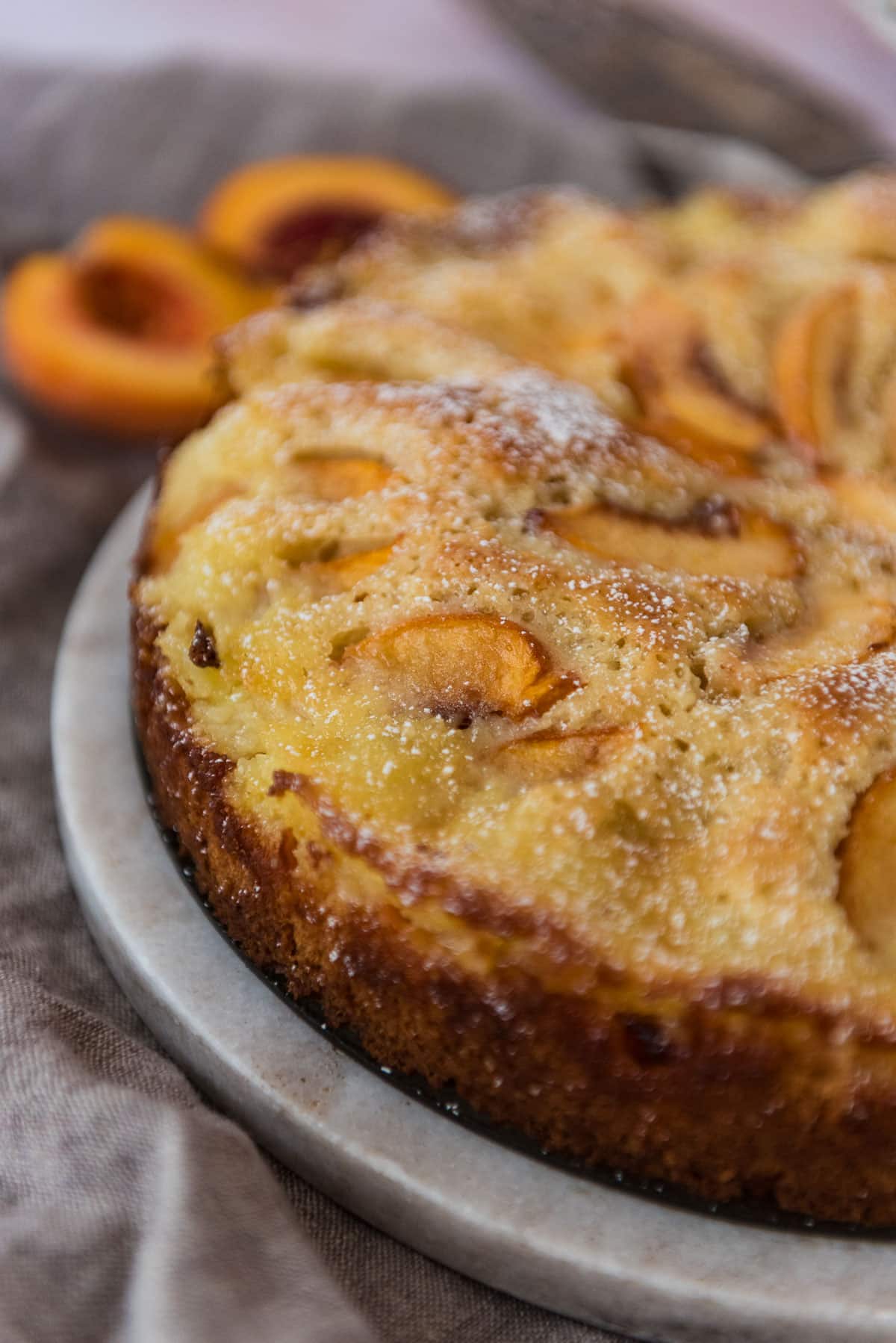 closeup view of German peach kuchen cake on serving platter
