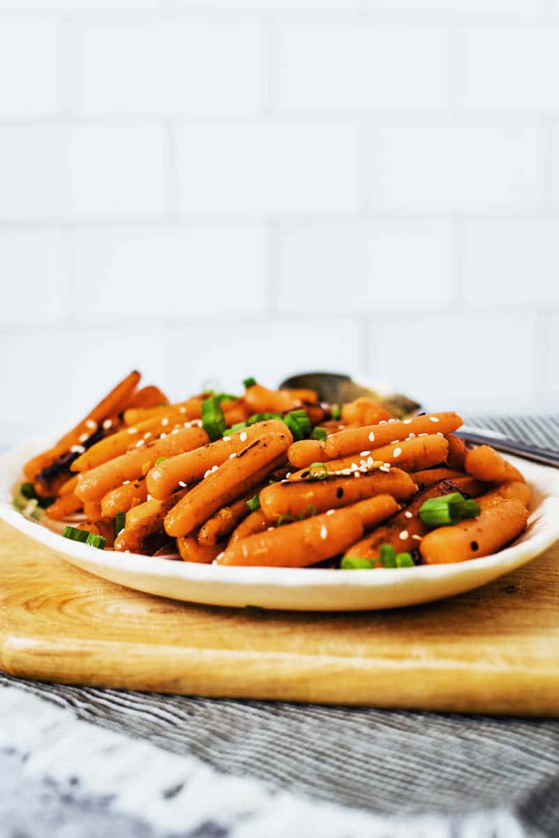 honey roasted baby carrots on white plate 