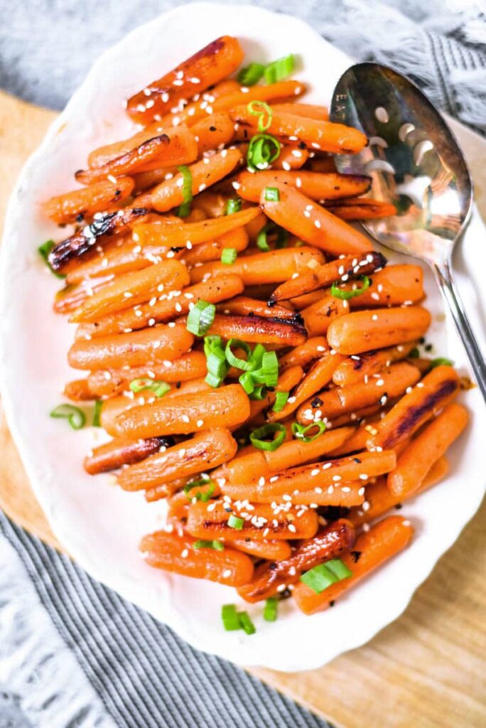 honey roasted baby carrots on white plate