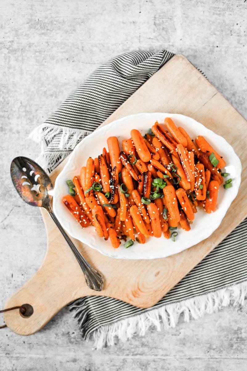 white plate with honey ginger roasted carrots
