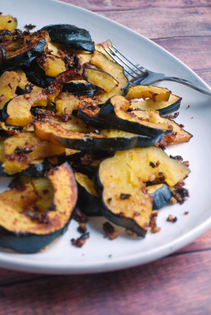 Roasted Acorn Squash Side Dish on white platter with fork in background