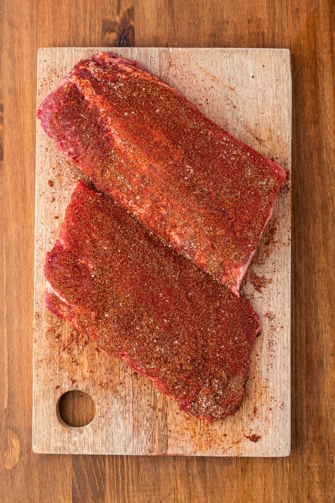 baby back ribs on cutting board rubbed with spice mix