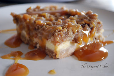 close up of cheesecake bar with caramel drizzled on plate