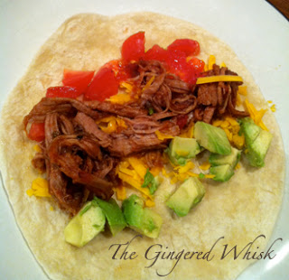 tortilla filled with shredded pork, tomato, cheese and avocado 