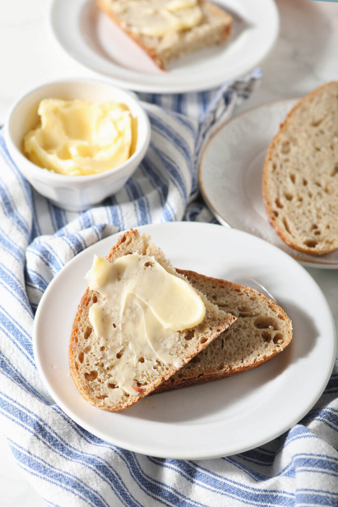 whole wheat sourdough slices on plate with butter