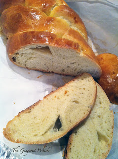 challah loaf with slices cut in front of it