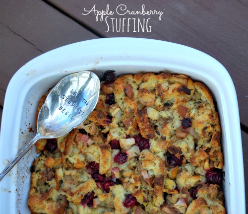 Apple Cranberry Stuffing in white baking dish with serving spoon