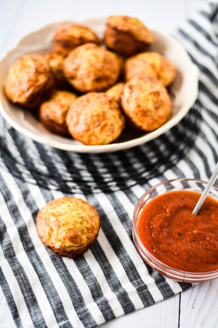 pizza bites in white bowl with marinara sauce