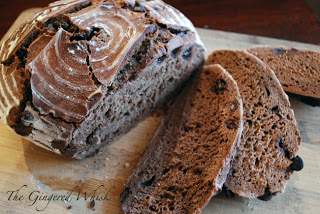 loaf of sourdough chocolate bread with slices beside 