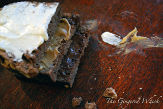 three slices of chocolate bread smeared with cream cheese, peanut butter, and nutella