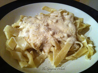 plate of homemade pasta with Alfredo sauce on top