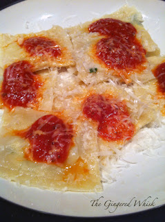 freshly made ravioli with red sauce and cheese