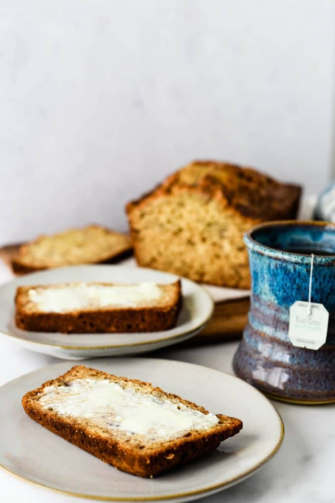 earl grey banana tea cake on plates with mug of tea beside