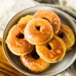 shallow bowl stacked with homemade sourdough donuts
