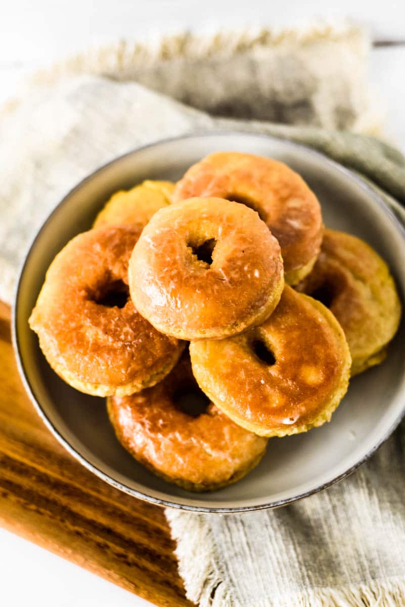 shallow bowl stacked with homemade sourdough donuts