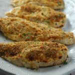 White platter with four chicken breasts with parmesan crust
