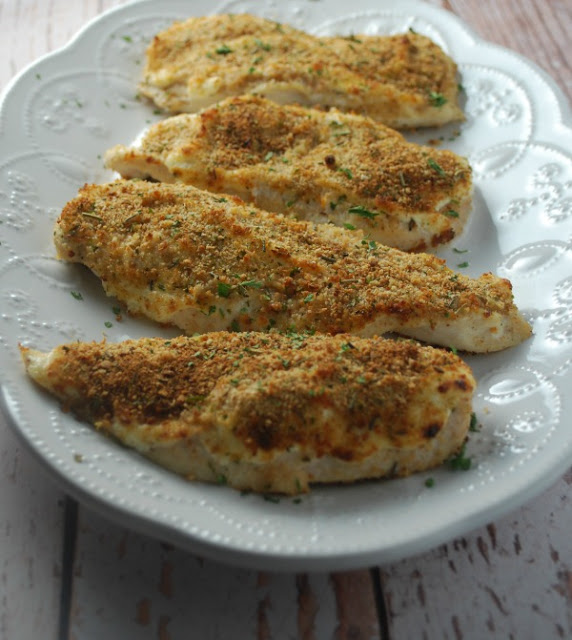 white platter with four parmesan crusted chicken breasts