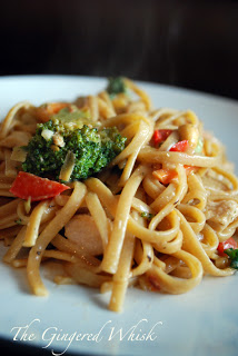 chicken pad thai on plate with red peppers and broccoli