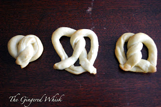 Three pretzels made with sourdough on table