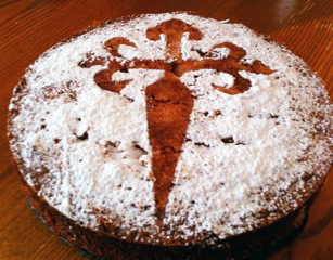 cake with powdered sugar topping, with a design made from a stencil