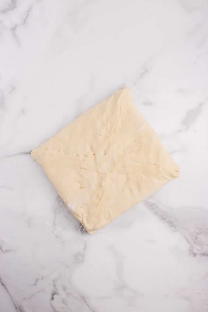 square of dough folded around square of butter