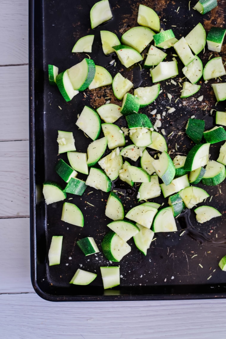 diced zucchini on roasting pan before baking