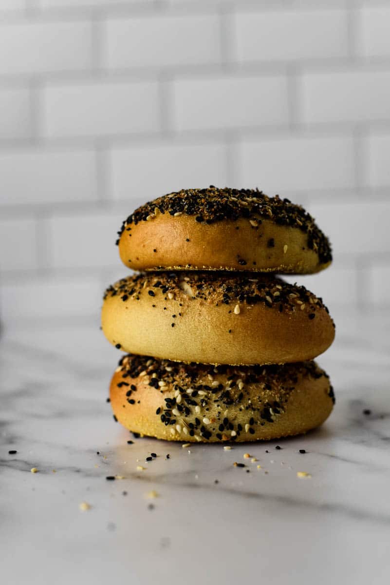 three sourdough bagels stacked on top of each other 