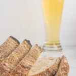 slices of sourdough bread with glass of beer behind