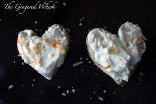 two shortbread cookies with pineapple cream and shredded coconut