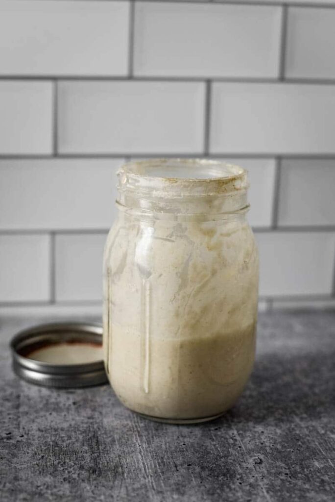 glass mason jar filled with sourdough starter