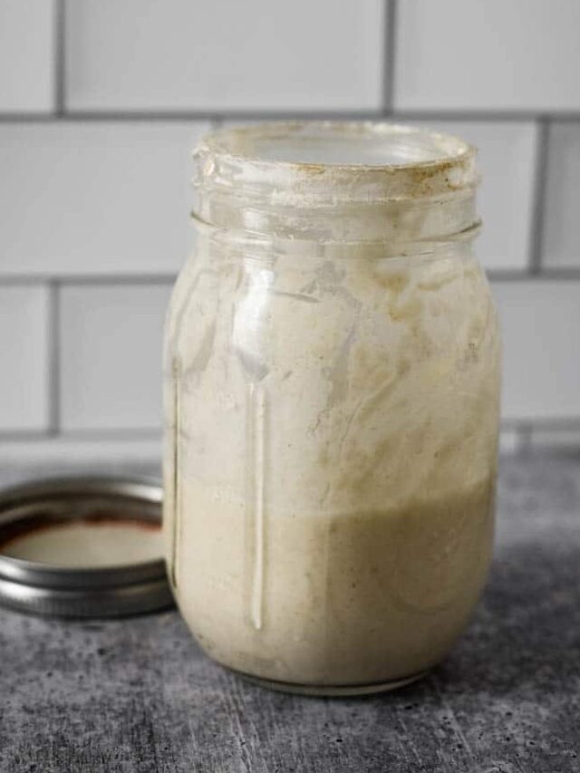 glass mason jar filled with sourdough starter