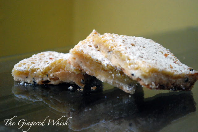 three lemon bars with earl grey tea on counter