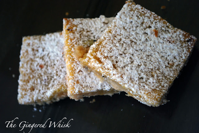 overhead view of three slices of lemon bars with powdered sugar on top