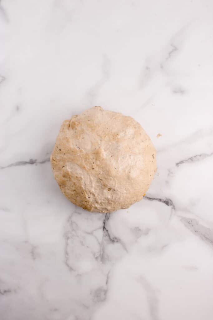 ball of dough on marble counter