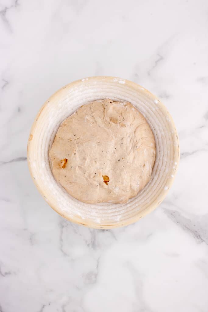 sourdough bread loaf in circle banneton basket