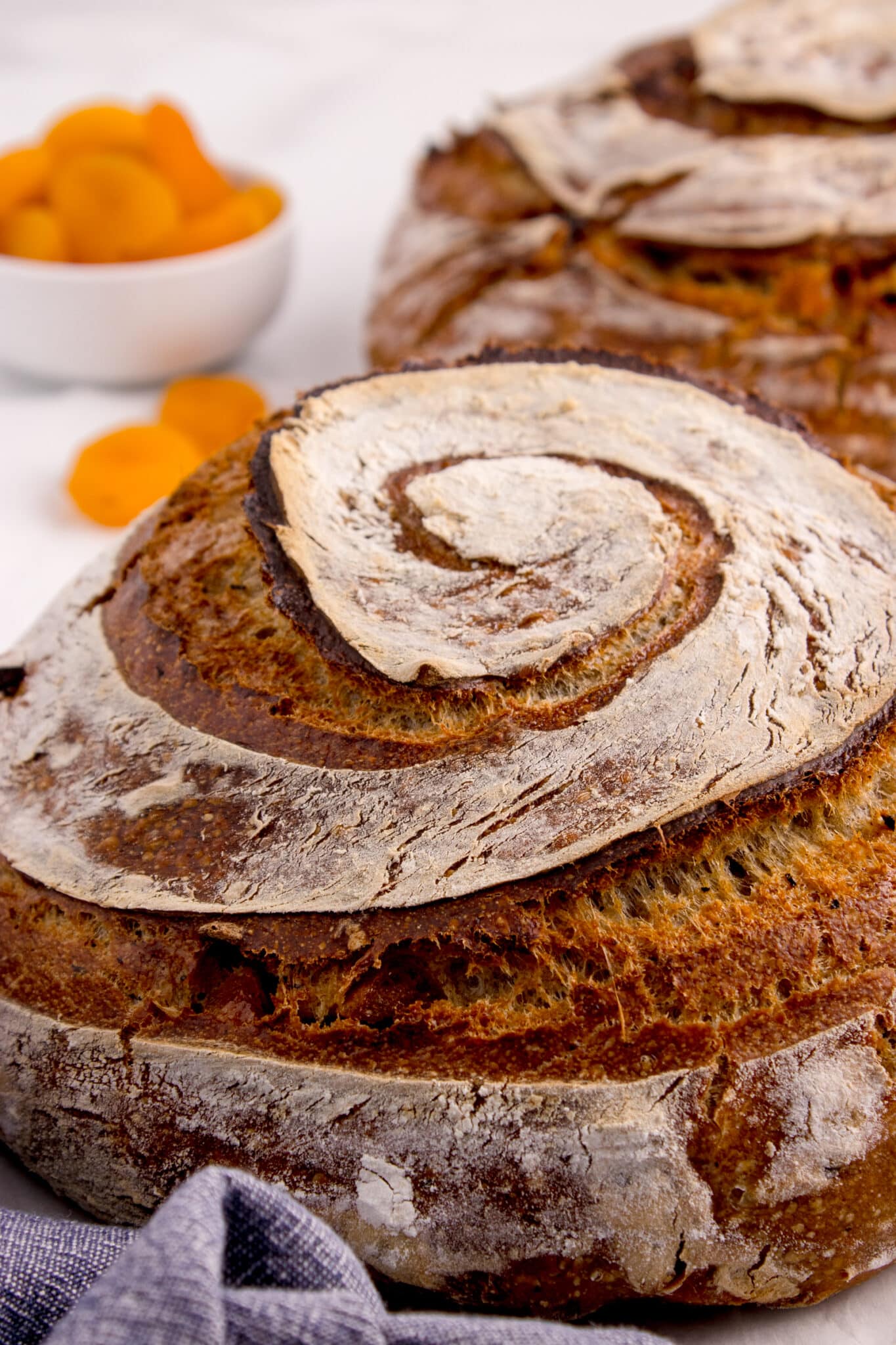 closeup of sourdough loaf showing swirled score pattern