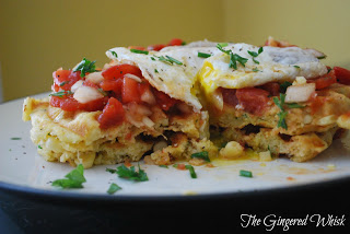 savory waffles with salsa and egg on plate, with bite taken out