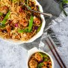 asian stir fry in white platter with meatballs and noodles