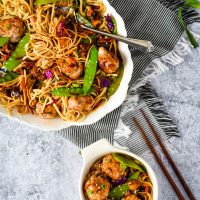 asian stir fry in white platter with meatballs and noodles