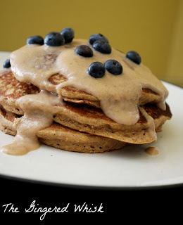 plate with sweet potatoes pancakes, drizzle of sauce and fresh blueberries 