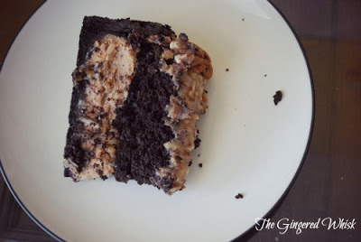 slice of german chocolate cheesecake on plate with crumbs