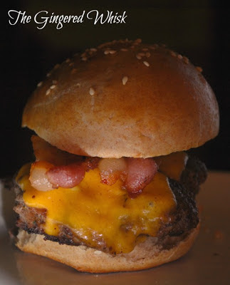 close up of venison burger on bun with bacon and cheese